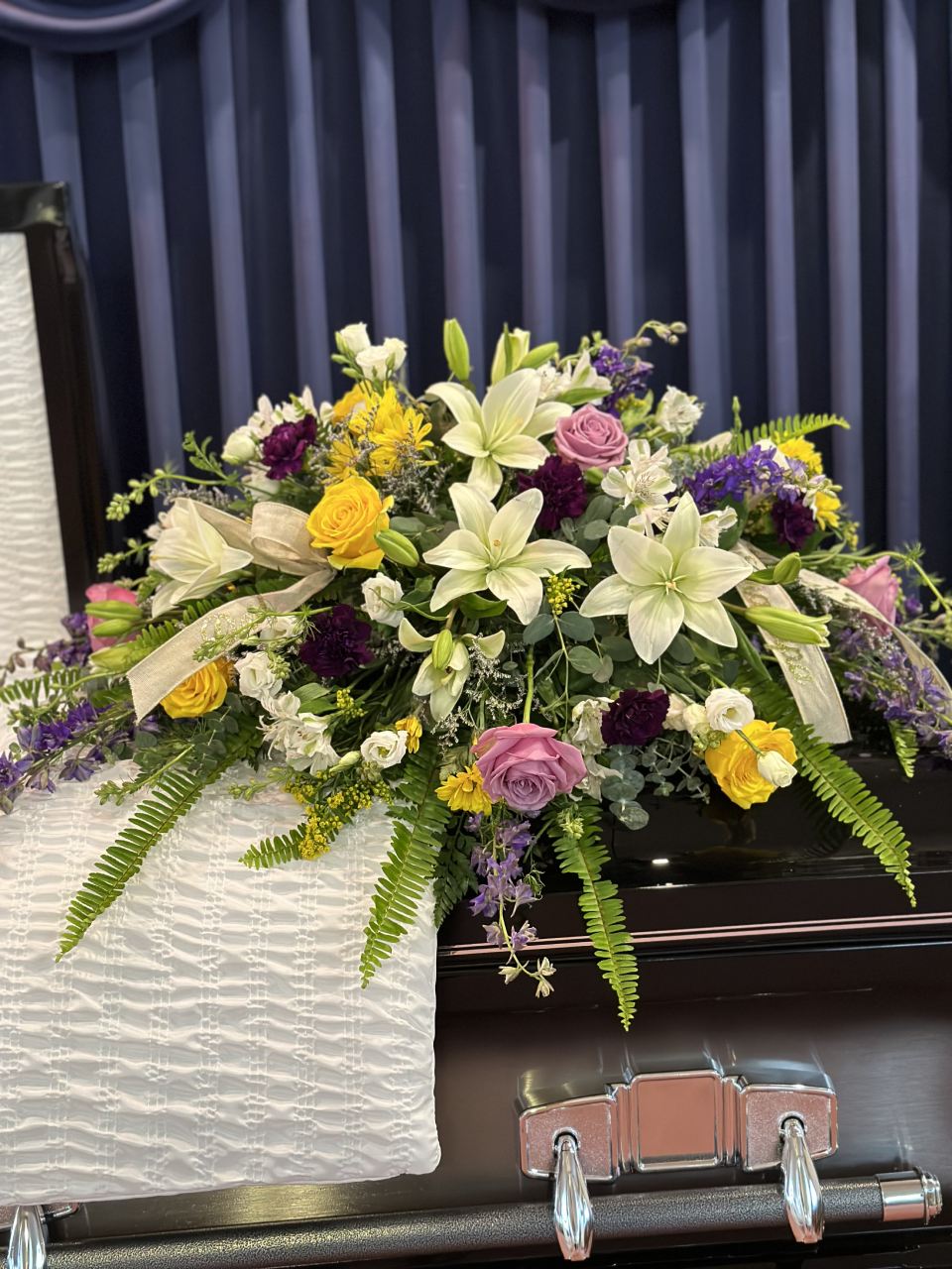 Funeral Floral Arrangement Funeral flower arrangement. Yellow and violet roses. While lilies.